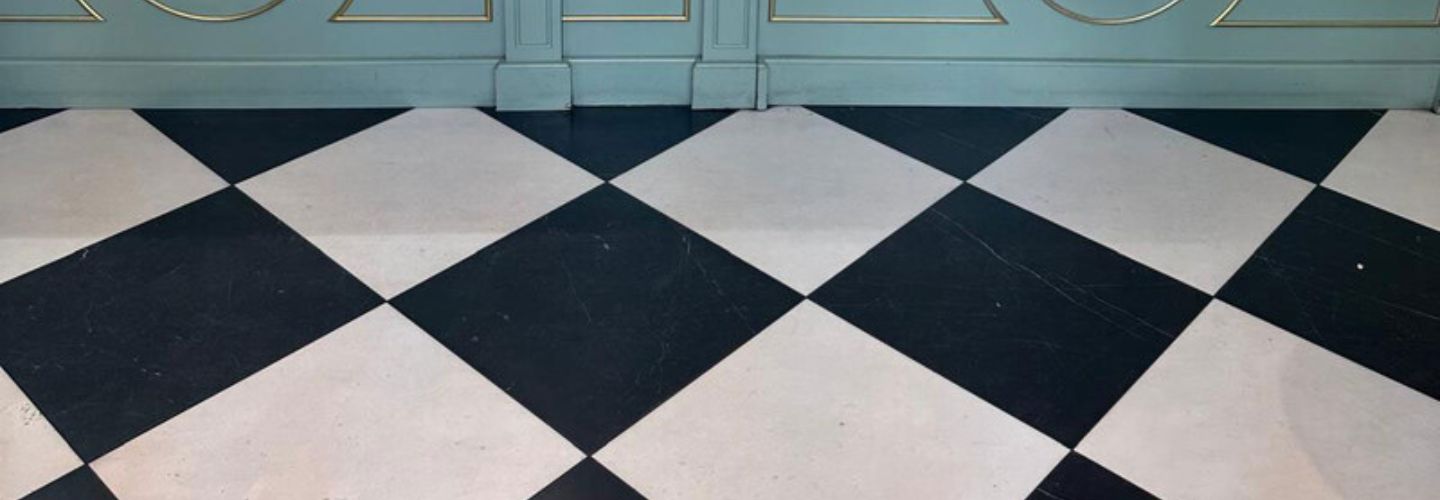 Black and white marble checkerboard floor in bake shop