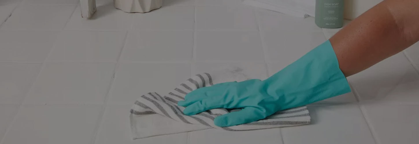 person cleaning tile floor