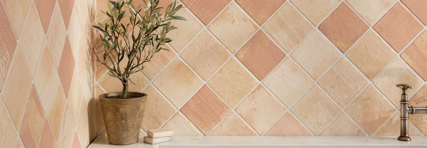 Terracotta-look tiles on bathroom wall in diamond pattern